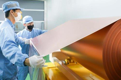 SK Nexilis employees examine the copper foil produced at the manufacturing complex in Jeongeup, North Jeolla Province on Oct. 12, 2022. (Yonhap)