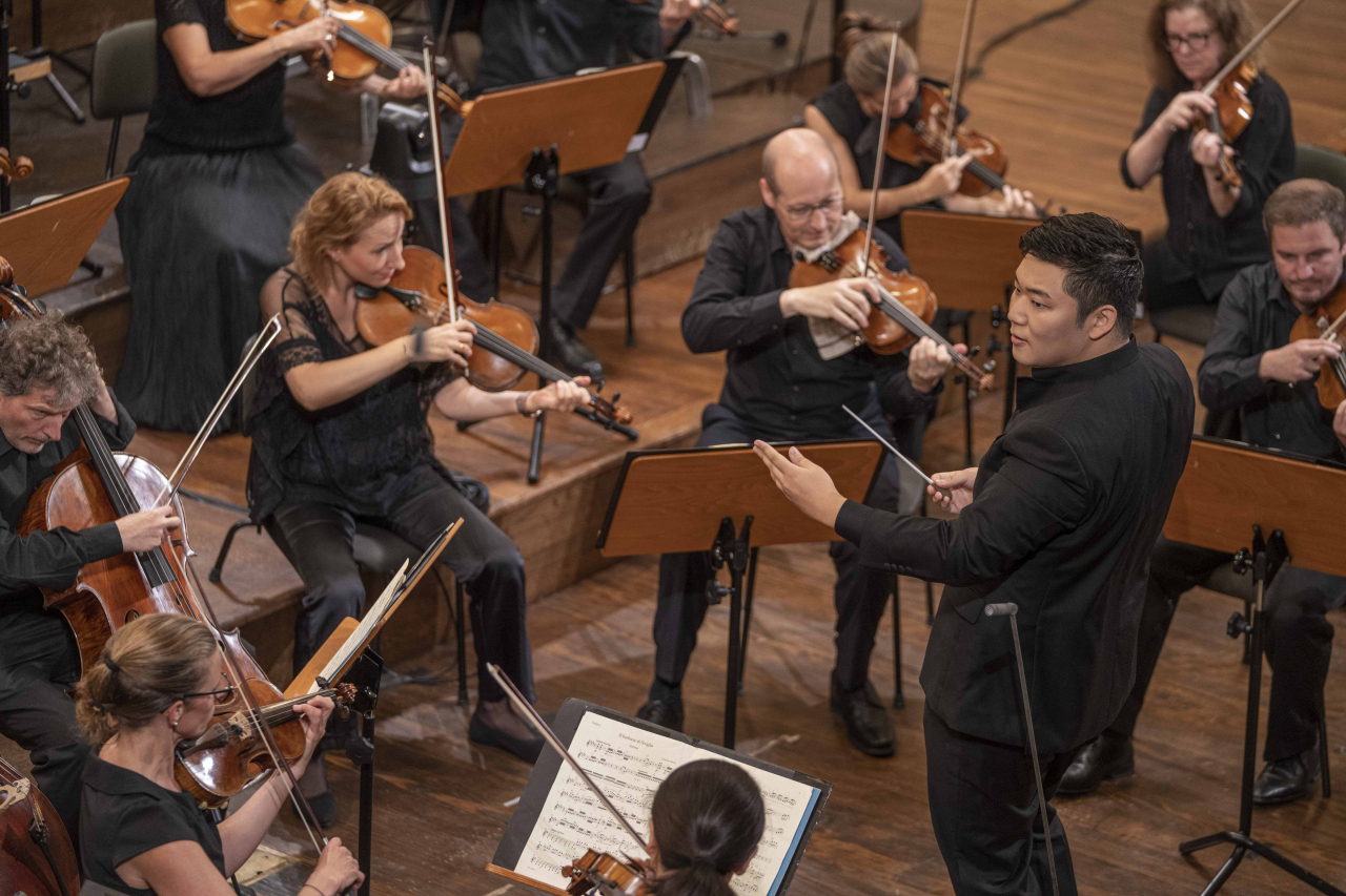 Yoon Han-kyeol conducts in the final round of the 2023 Herbert von Karajan Young Conductors Award in the main auditorium of the Salzburg Mozarteum Foundation in Salzburg, Austria, on Sunday. (Salzburg Festival)