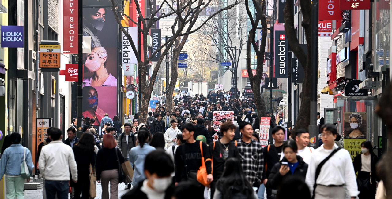 People walk on the main street in the Myeong-dong area, Seoul, on April 1. (Im Se-jun/The Korea Herald)