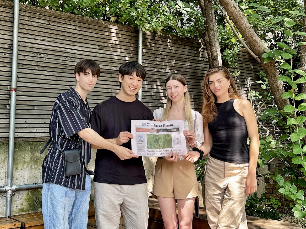 Pohim Tam (second from left) holds a copy of The Korea Herald with his friends, Evans Becker (first from left), Hailey Kellum (third from left) and Rachel Millet (fourth from left). (Courtesy of Pohim Tam)