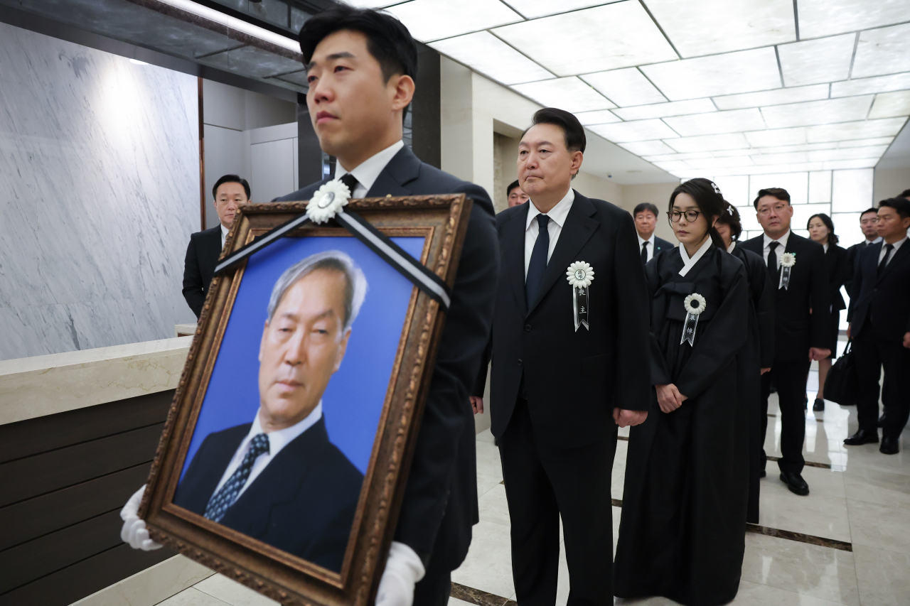 President Yoon Suk Yeol (second from left) and first lady Kim Keon Hee (third from left) walk behind a portrait of Yoon's late father, Yoon Ki-jung, during his funeral at Severance Hospital in Seoul on Thursday. (The presidential office)