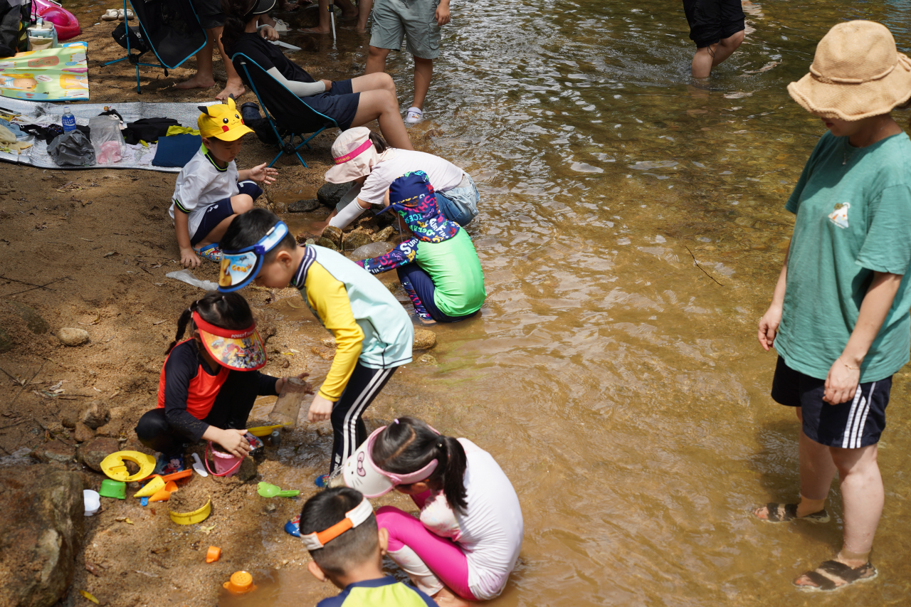 Children play in the water at Gwanaksan's Sillim Gyegok in Gwanak-gu, southern Seoul on Tuesday. (Lee Si-jin/The Korea Herald)