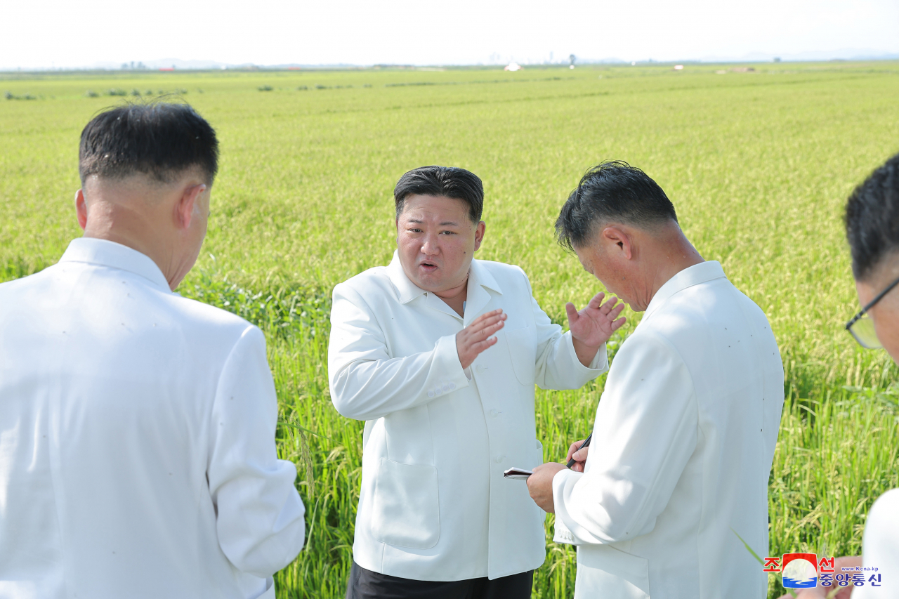 This photo shows North Korean leader Kim Jong-un (center) inspecting farms in the typhoon-hit county of Anbyon in Kangwon Province on Friday. (KCNA)