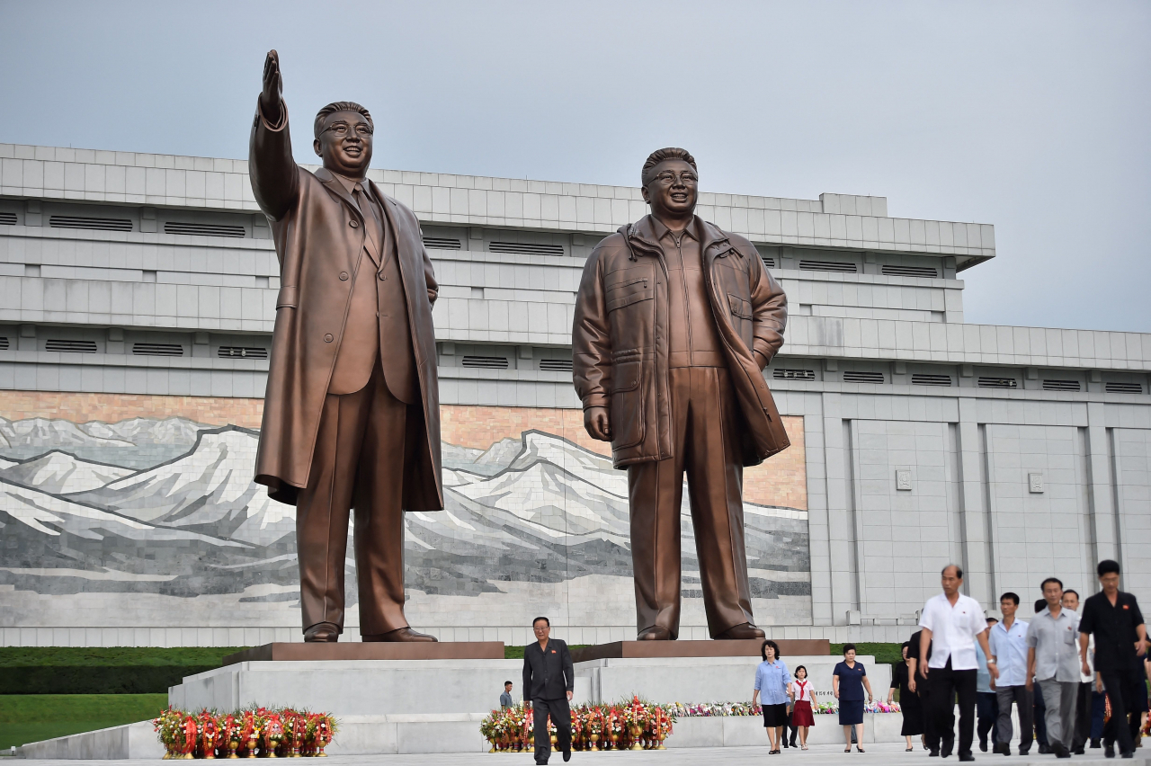 People leave after paying their respects before the statues of late North Korean leaders Kim Il Sung and Kim Jong Il at Mansu Hill as North Korea marks its 78th National Liberation Day, commemorating the end of Japanese colonial rule at the end of World War II, in Pyongyang on Tuesday. (AFP-Yonhap)