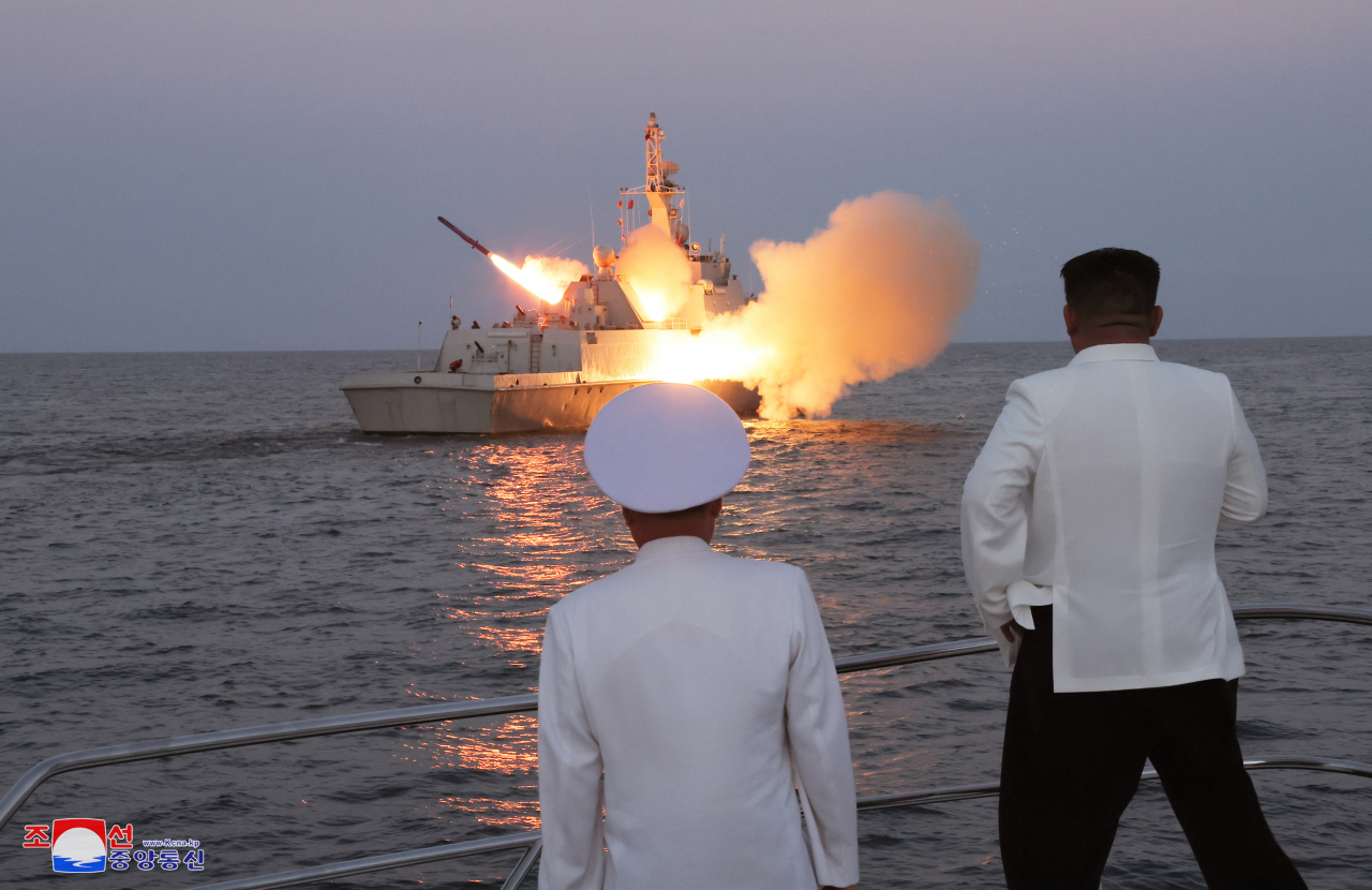 This undated photo, released by North Korea's official Korean Central News Agency on Monday, shows North Korean leader Kim Jong-un (right) on a patrol boat watching a test launch of what it has called a strategic cruise missile during a visit to the Guards 2nd Surface Ship Flotilla of the East Sea Fleet of North Korea's navy. The test was apparently made in a bid to respond to South Korea and the United States' annual military exercise, Ulchi Freedom Shield, which kicked off Monday for an 11-day run. (Yonhap)