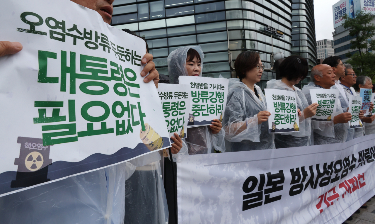 Members of civic groups hold a press conference in front of the Japanese Embassy in Seoul, criticizing President Yoon Suk Yeol for 