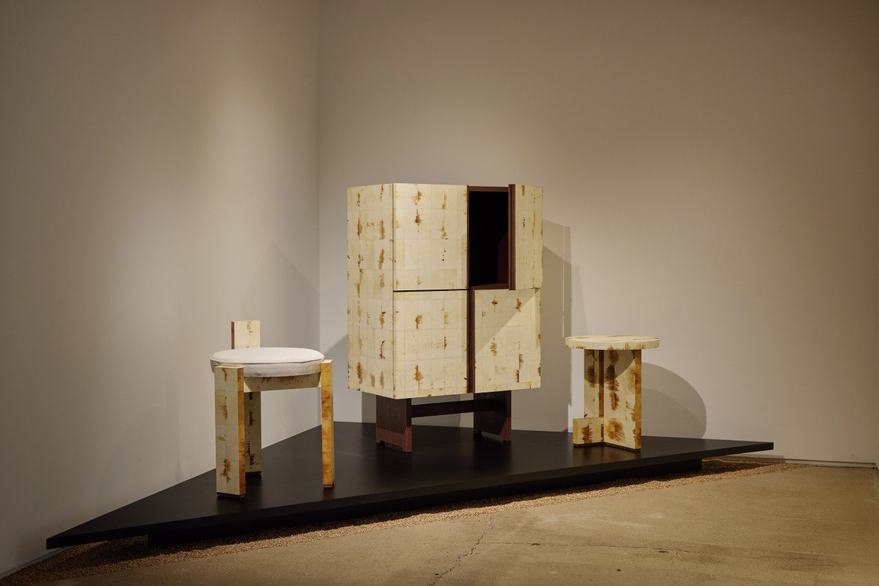 A cabinet and two chairs that are covered with flattened ox horn are on display. (Yeol)