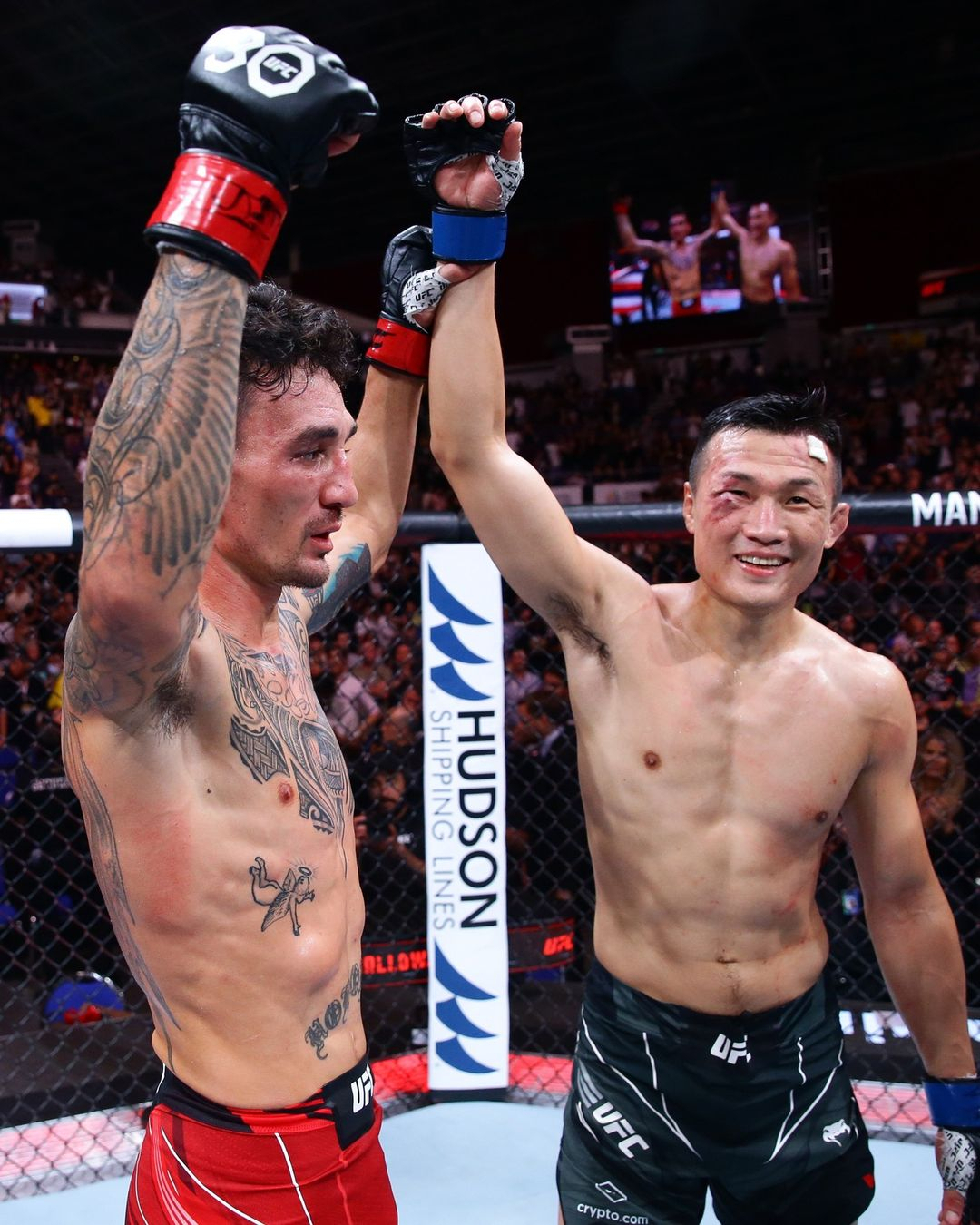Max Holloway raises Jung's hands after winning the fight via knockout in the third round (Courtesy of UFC's Instagram)