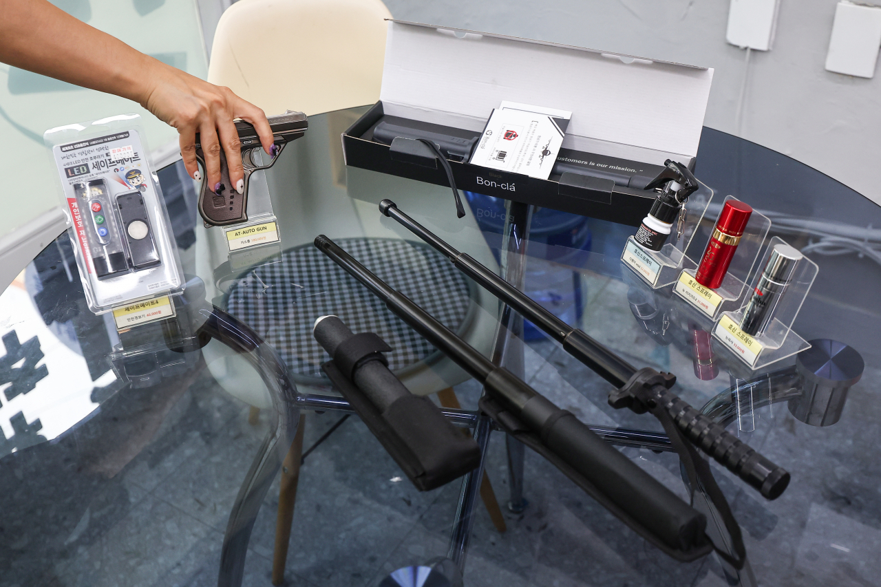 Self-defense weapons such as gas pistols, stun guns, metal batons and pepper spray are on display as products being sold at a self-defense weapons store in Bucheon, Gyeonggi Province. (Yonhap)