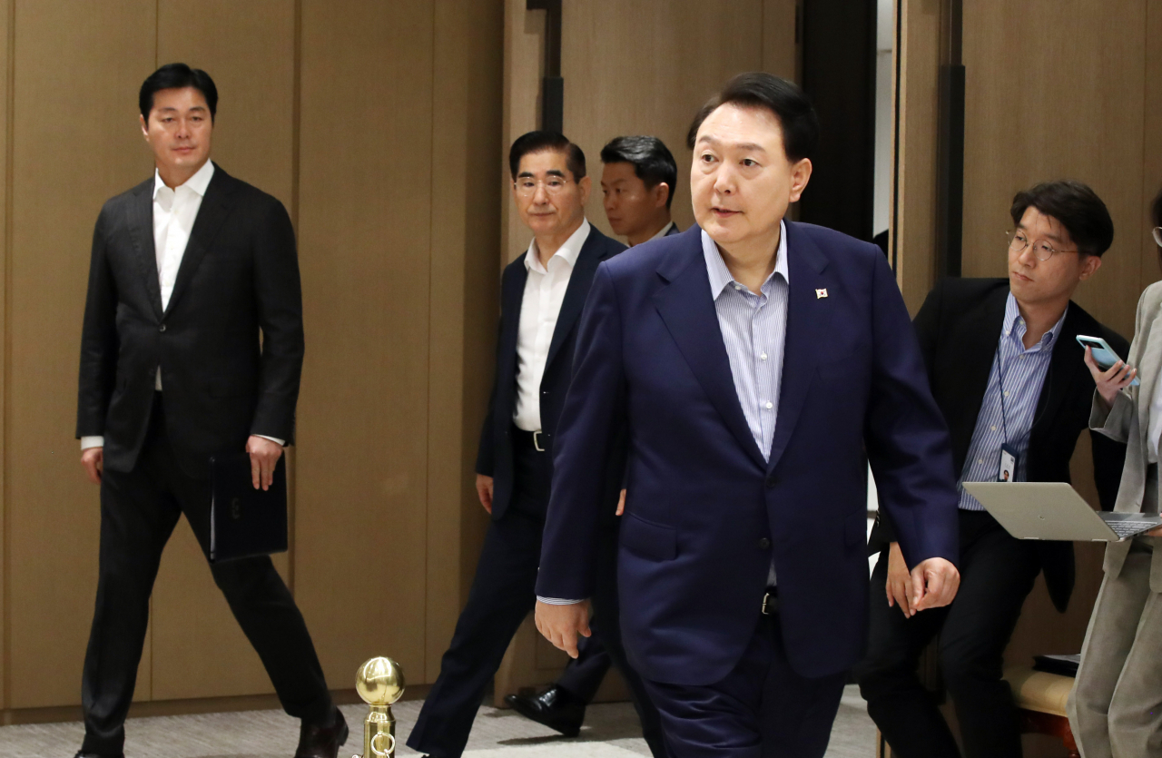 President Yoon Suk Yeol (front) enters the presidential office meeting room to preside over the Emergency Meeting on Economic Affairs in Seoul, Thursday. (Joint Press Corps)
