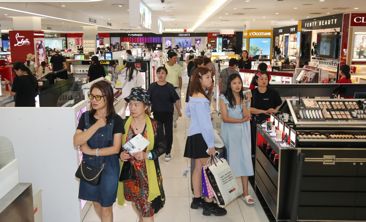 Travelers shop at the Shilla Duty Free Jeju Downtown Store on Thursday. (Newsis)