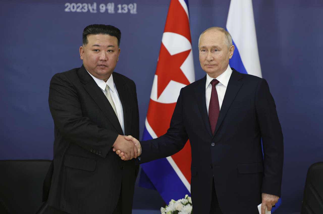 Russian President Vladimir Putin, right, and North Korea's leader Kim Jong-un shake hands during their meeting at the Vostochny cosmodrome outside the city of Tsiolkovsky, about 200 kilometers (125 miles) from the city of Blagoveshchensk in the far eastern Amur region, Russia, on Wednesday, Sept. 13, 2023. (Yonhap-AP)