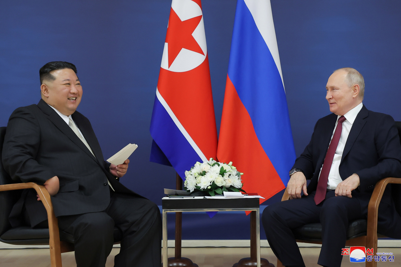 North Korean leader Kim Jong-un (left) holds talks with Russian President Vladimir Putin at the Vostochny Cosmodrome space launch center in the Russian Far East on Wednesday in this photo released by the North's official Korean Central News Agency the next day. (Yonhap)