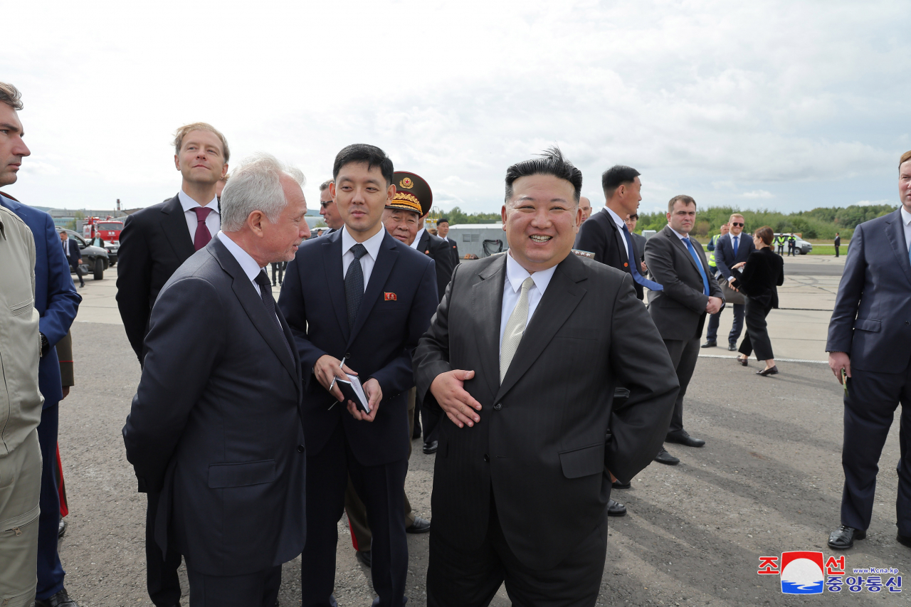 North Korean leader Kim Jong-un (Center) smiles as he visits the Yuri Gagarin Aviation Plant in Komsomolsk-on-Amur, Russia on Friday. (KCNA)