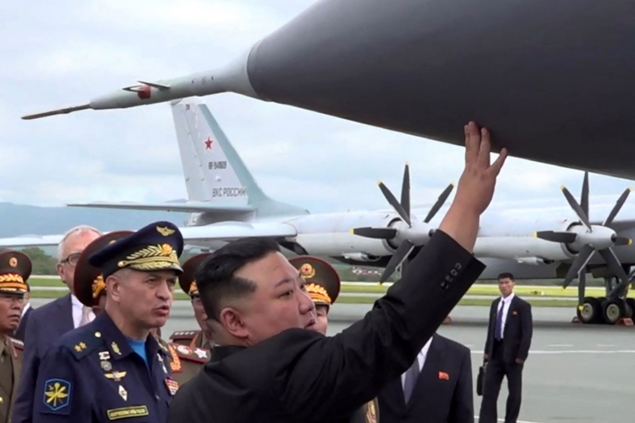 In this video grab taken from a handout footage released on Saturday by the Russian Defense Ministry, North Korea's leader Kim Jong-un inspects a Russian warplane as he visits Knevichi aerodrome near Vladivostok, Primorsky region. (AFP)