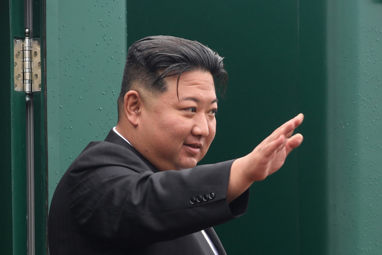 In this handout photograph taken and released by the Government of the Primorsky region on Sunday, North Korea's leader Kim Jong-un waves before boarding a train during a farewell ceremony at the end of his visit to Russia at the Artyom railway station near Vladivostok, in the Primorsky region. (AFP)