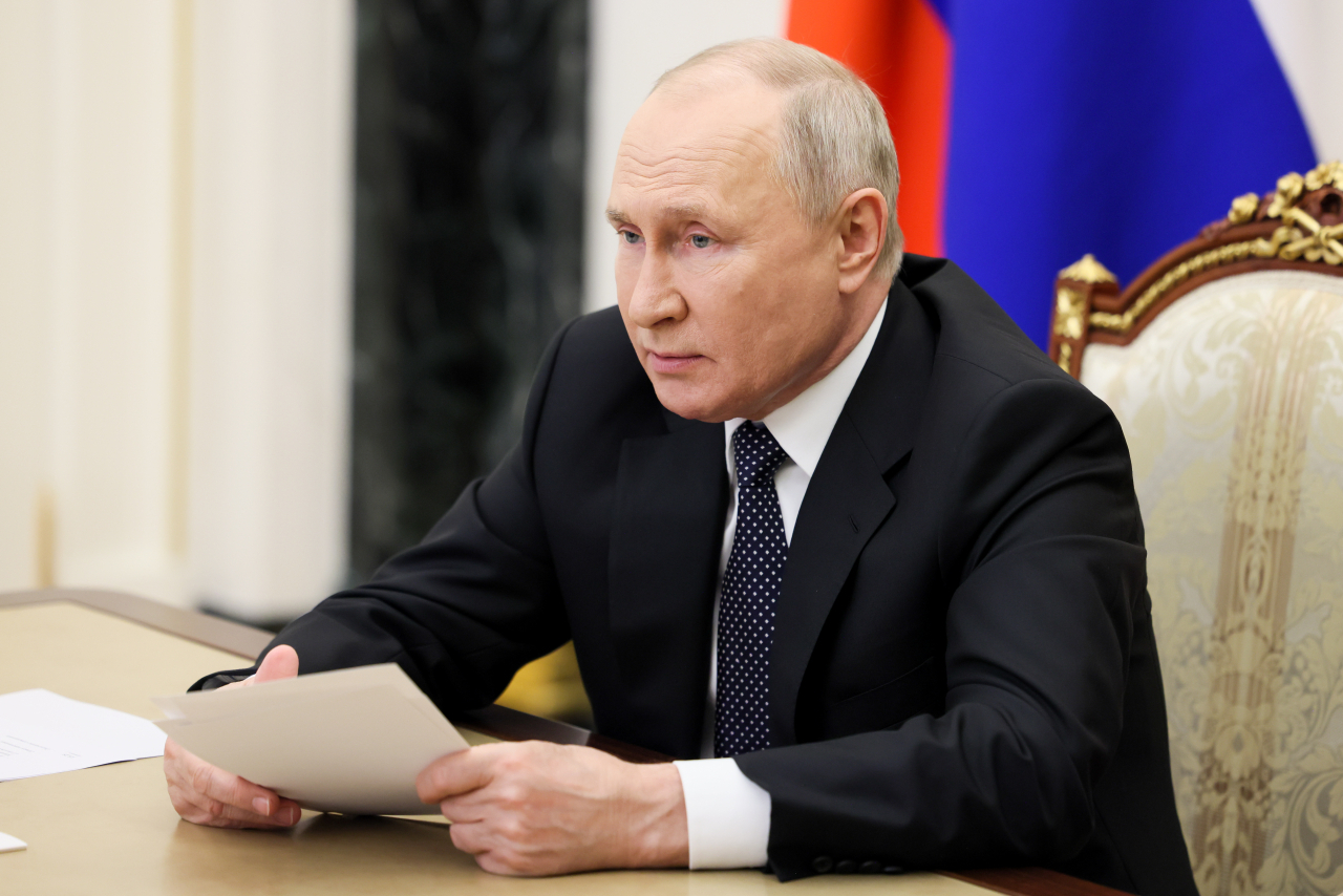 Russia's President Vladimir Putin is seen in his office in the Kremlin during a videoconference meeting of Russian government officials to discuss Russia's draft federal budget for 2024-2026. (TASS-Yonhap)