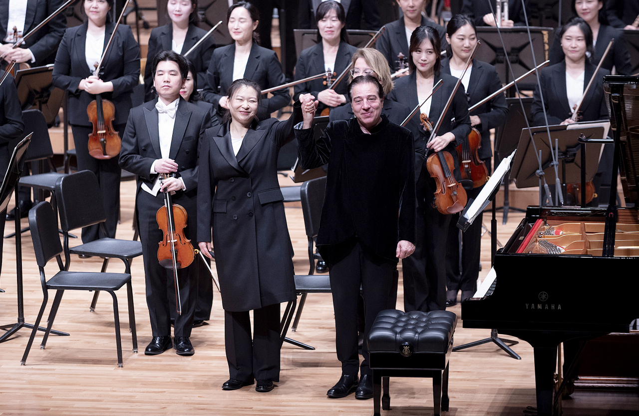 Korean conductor Sung Shi-yeon and Turkish pianist and composer Fazil Say stand after performing Say's 