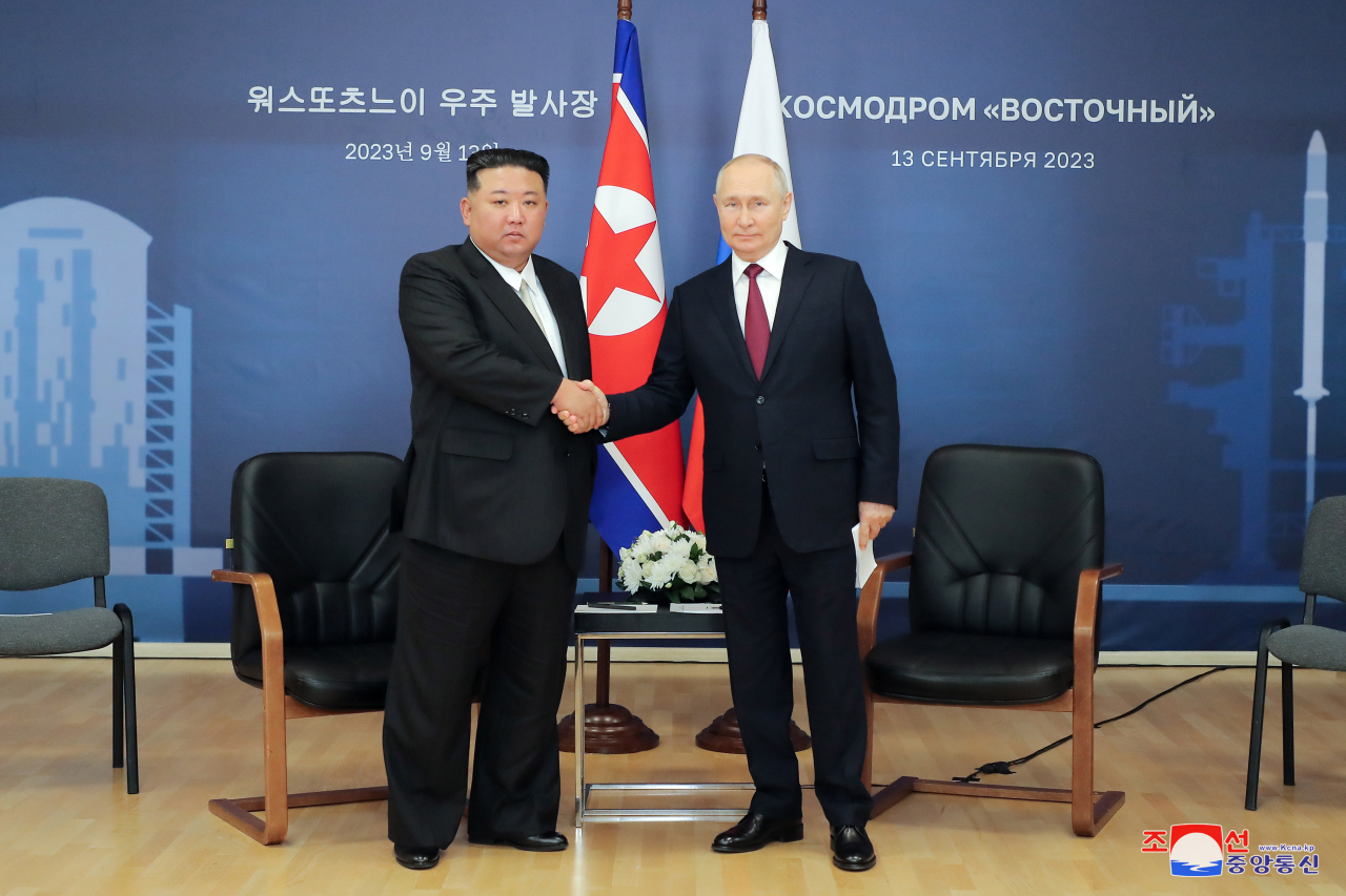 North Korean leader Kim Jong-un (left) shakes hands with Russian President Vladimir Putin ahead of their talks at the Vostochny Cosmodrome space launch center in the Russian Far East on Sept. 13 in the photo released by the North's official Korean Central News Agency the next day. (Yonhap)