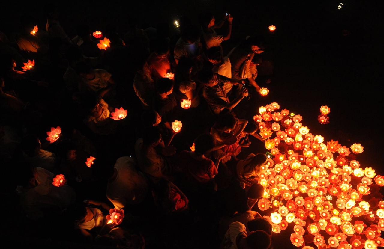 People lay lanterns on a river in Chengdu, China, during the Mid-Autumn Festival in 2008. (Getty Images)