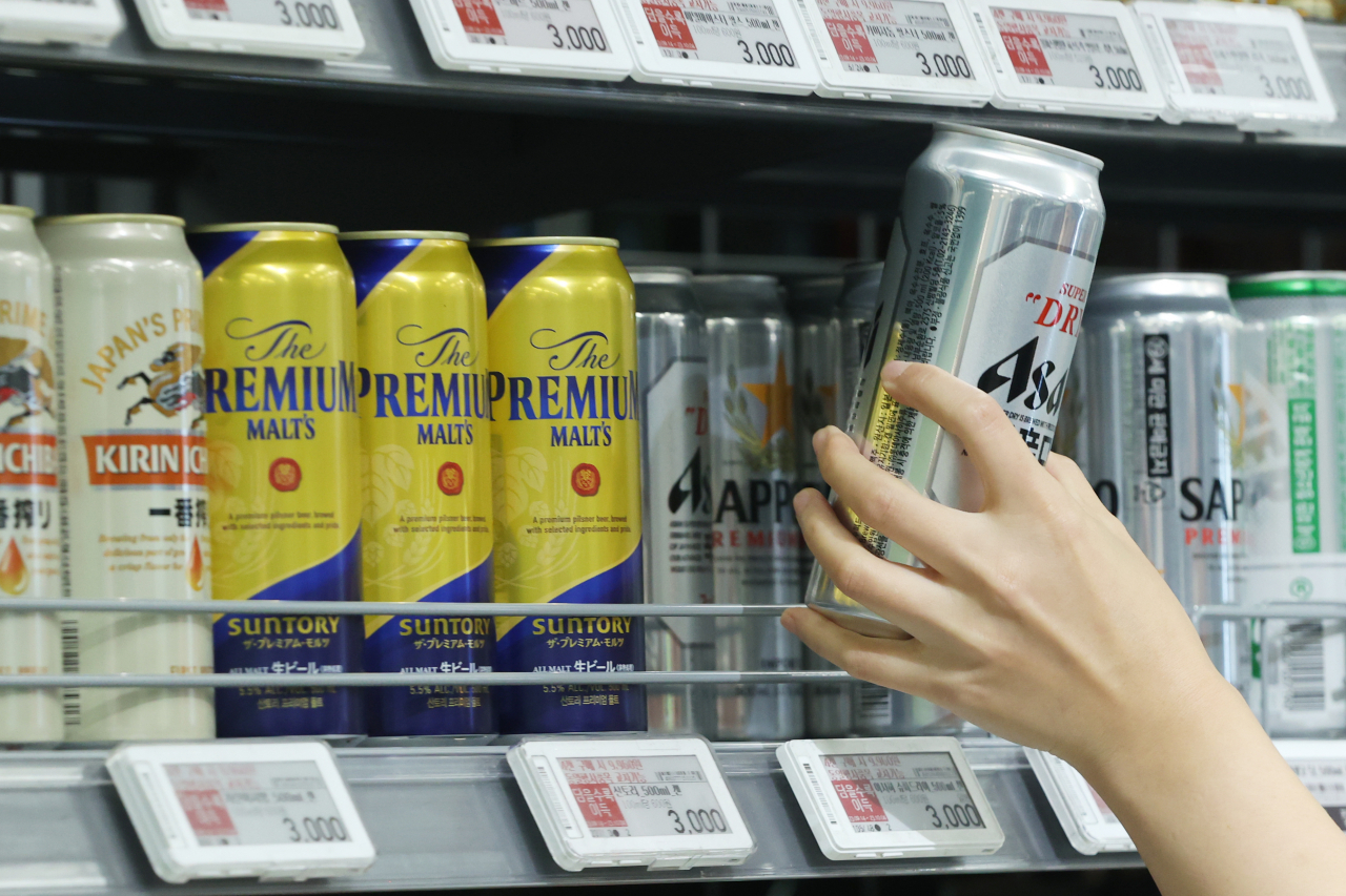 A shopper picks up a can of Japanese beer at a supermarket in Seoul, Sept. 18. (Yonhap)