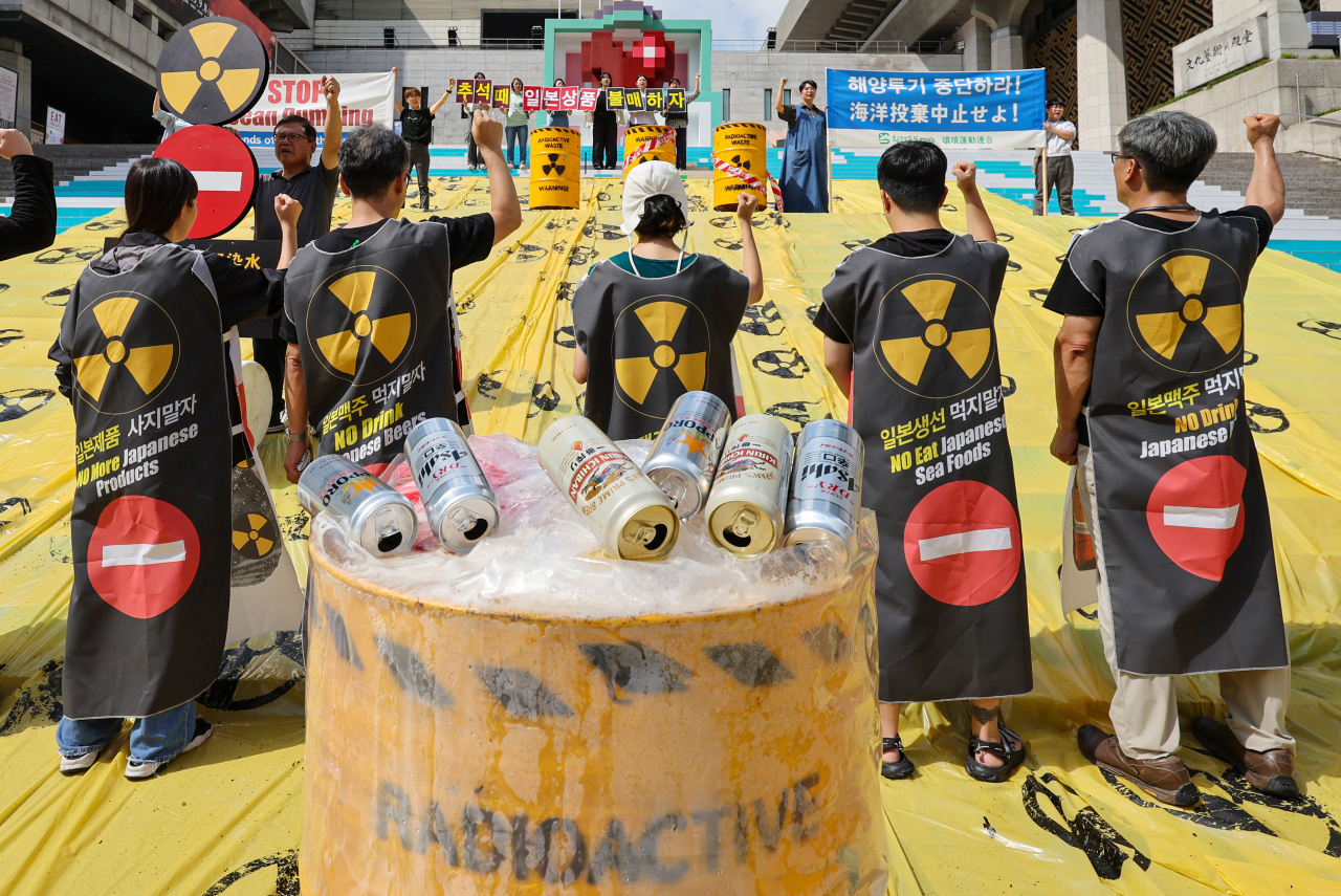 Members of environmental groups protest the Japanese government's decision to start releasing radioactive wastewater from the destroyed Fukushima Daiichi nuclear power plant into the ocean in front of Sejong Center for the Performing Arts in Seoul, Aug. 18. (Yonhap)