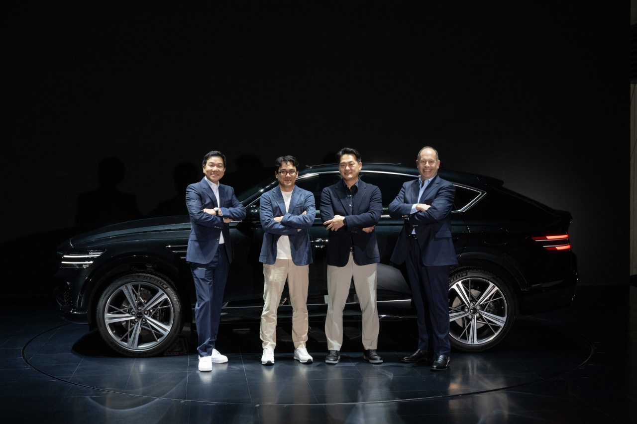 From left: Lee Sang-yeob, head of the Genesis Design Center; Yoon Il-heon, Genesis design director; Ahn Se-jin, director of the Genesis project 2; and Graeme Russell, Genesis chief brand officer, pose for a photo in front of the GV80 Coupe after a press conference in Yongin, Gyeonggi Province, Tuesday. (Hyundai Motor Group)