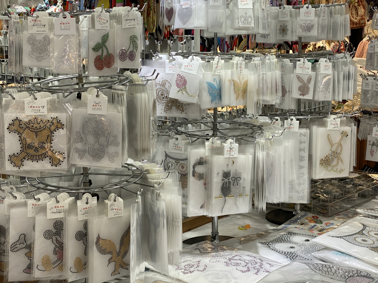 A variety of glitter stickers are hung on the stand. (Hwang Joo-young/The Korea Herald)