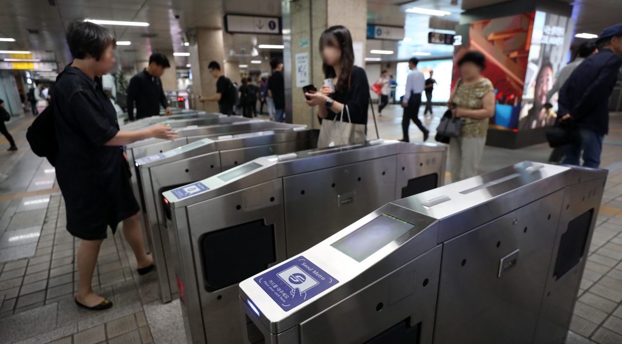 Passengers pass through the turnstiles in a subway station in Seoul on Oct. 3. (Newsis)
