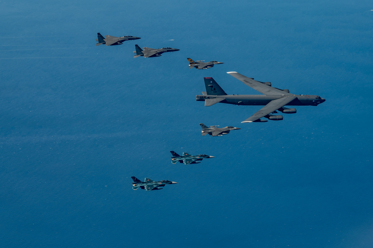 The US Air Force's nuclear-capable B-52 heavy bomber conducts a formation flight while being escorted by fighter jets from South Korea, the US, and Japan during a first-ever trilateral air exercise on Sunday south of the Korean Peninsula. (United States Air Force)