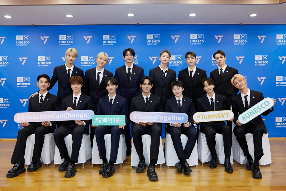 A picture provided by Pledis Entertainment shows Seventeen members posing after they sign a business partnership for the 
