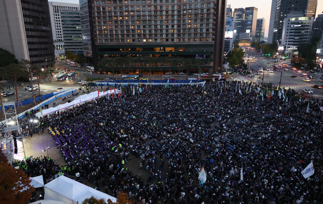 People gather in front of the Seoul City Hall to mark the first anniversary of the Itaewon disaster that claimed 159 lives last year. (Yonhap)