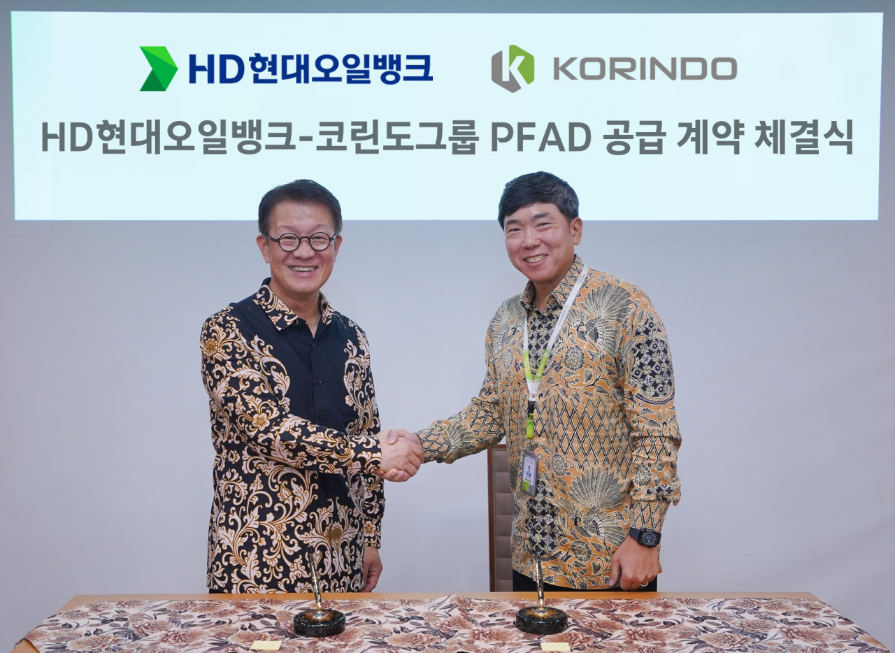 HD Hyundai Oilbank CEO Chu Young-min (left) shakes hands with Korindo Group Chairman Robert Seung after signing an agreement at Korindo Group's headquarters in Jakarta, Indonesia, in October. (HD Hyundai Oilbank)