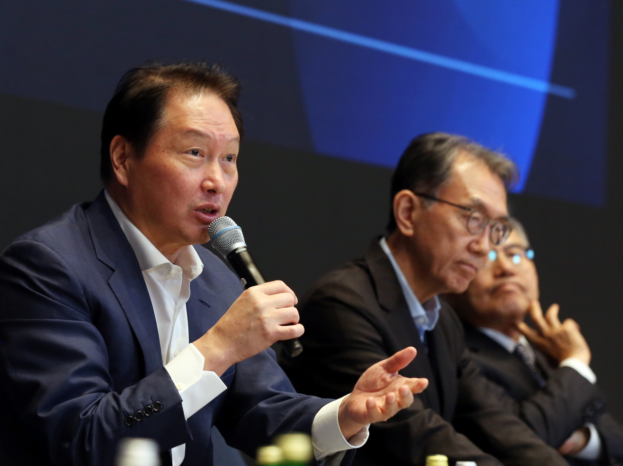 SK Group Chairman Chey Tae-won (left) speaks during a panel discussion session at the SK Directors' Summit 2023 in Seoul on Tuesday. (SK Group)