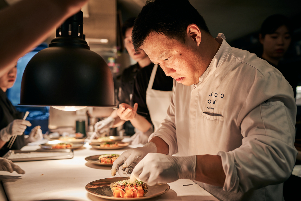 Shin Chang-ho, head chef of Korean contemporary restaurant Joo Ok, prepares a dish during the Korean Food Promotion Institution's 