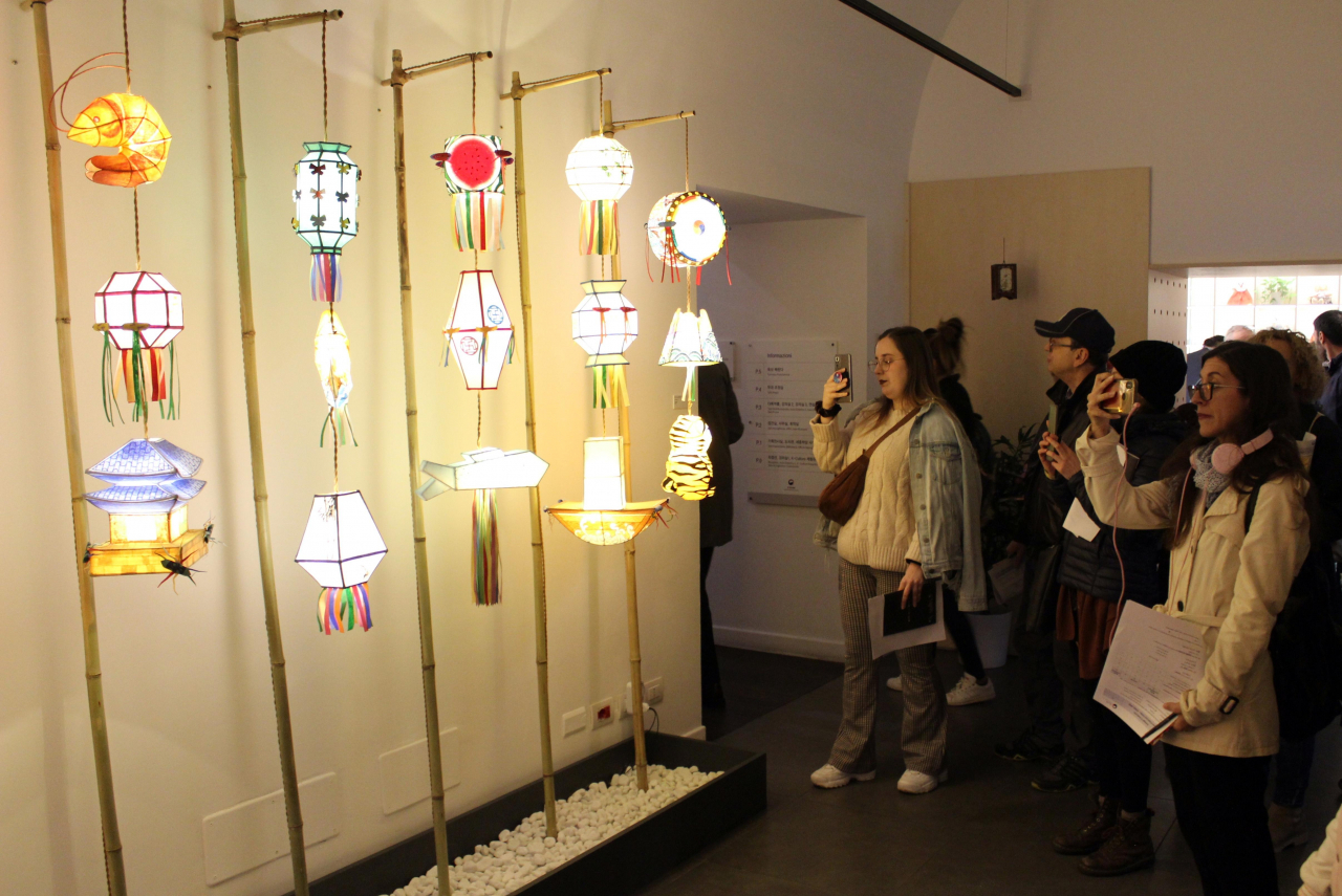 Visitors take photos of lanterns displayed at the exhibition 