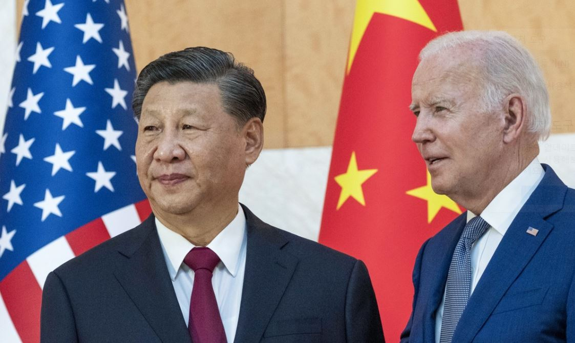 This Associated Press file photo, taken Nov. 14, 2022, shows US President Joe Biden (right) standing with Chinese President Xi Jinping before a meeting on the sidelines of the Group of 20 summit meeting in Bali, Indonesia. (Yonhap)