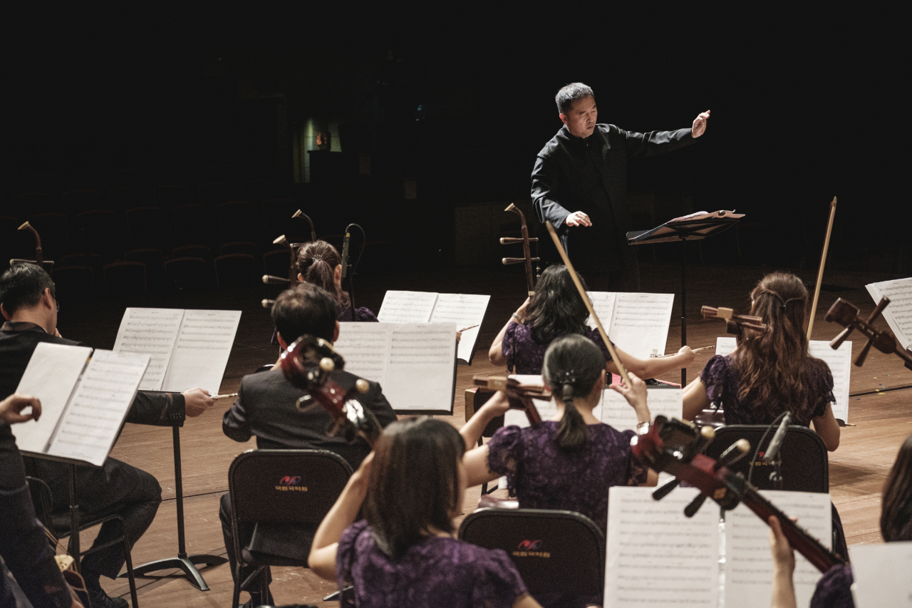 Music director Paul Ching-Po Chiang conducts during a rehearsal for a joint concert, 