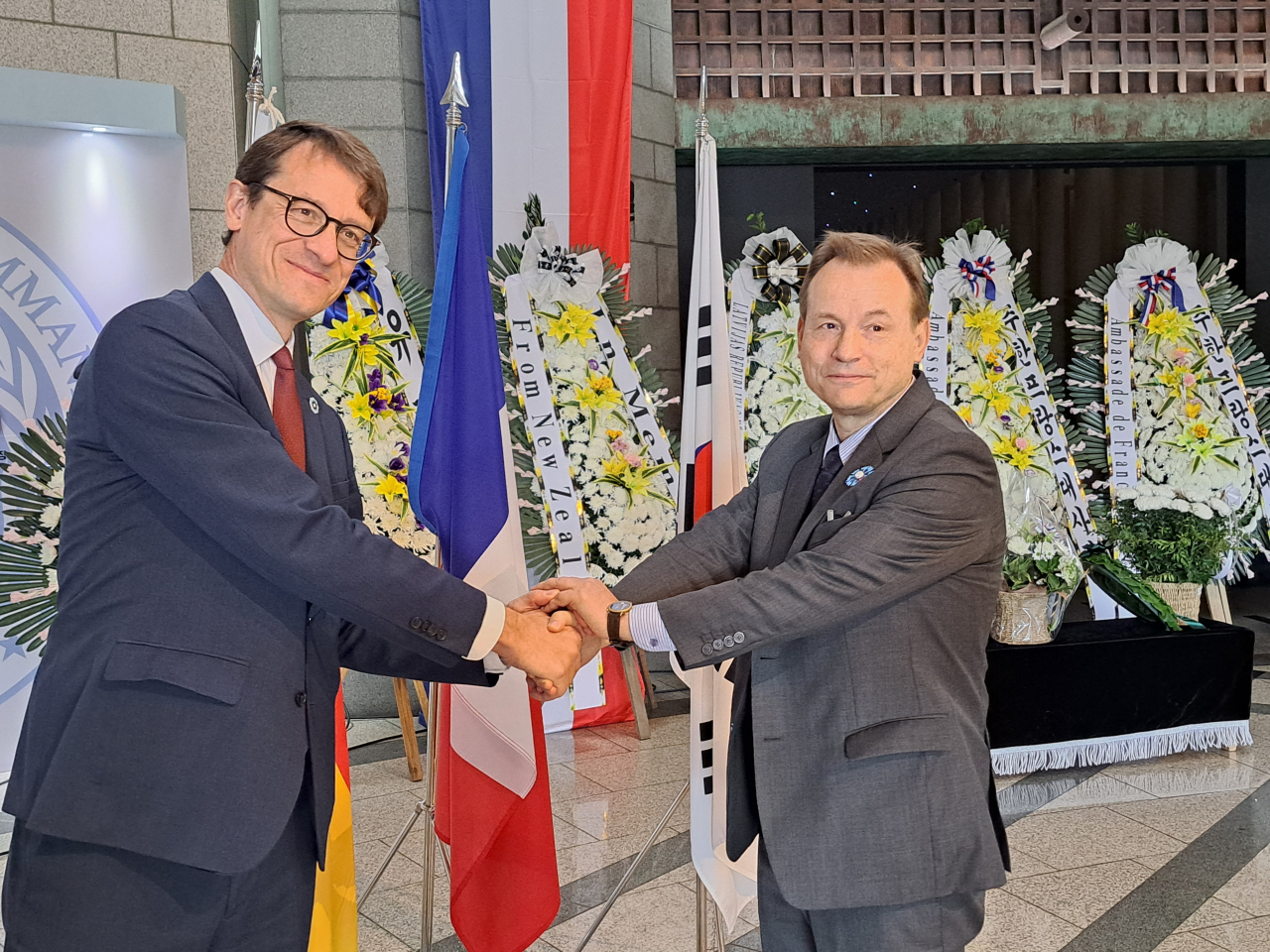 French Ambassador to Korea Philippe Bertoux (left) and German Ambassador to Korea Georg Schmidt attend a memorial and wreath-laying ceremony marking the 105th anniversary of the end of World War I, known as Armistice Day, on Friday. World War I officially concluded with the signing of the Treaty of Versailles on June 28, 1919, at the Palace of Versailles outside the town of Versailles, France. Armistice Day, observed annually on November 11th, commemorates the end of hostilities on the Western Front and pays tribute to the bravery and sacrifice of those who served during the war. (French Embassy in Seoul)