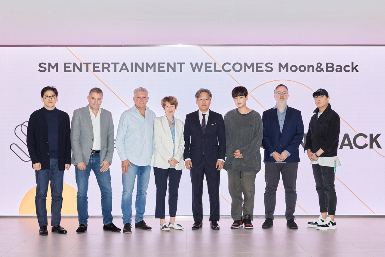(From left) SM CAO Lee Sung-soo; M&B co-CEOs Nigel Hall, Russ Lindsay and Dawn Airey; SM CEO Jang Cheol-hyuk; SM Creative Executive Kangta; SM Music Executive Ben Karter; and SM CBO Joseph Chang gathered in Seoul to sign a strategic partnership. (SM Entertainment)