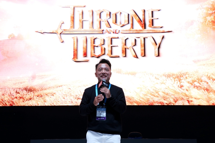 NCSoft CEO Kim Taek-jin speaks during a surprising appearance at the company's booth in G-Star 2023. (NCSoft)