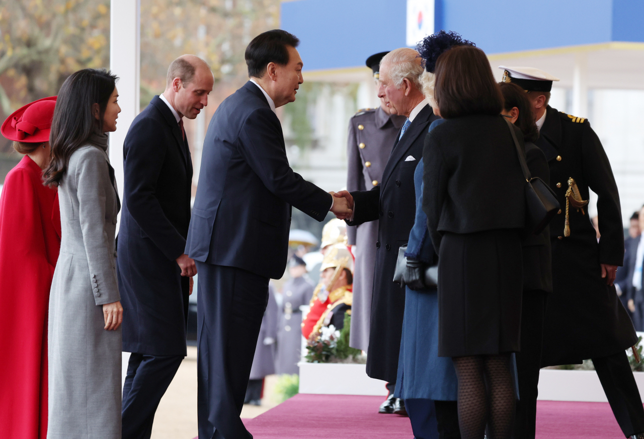 South Korean President Yoon Suk Yeol (third from left) shakes hands with King Charles III as he joins an official welcome ceremony held at Horse Guards Parade in London on Tuesday. (Yonhap)