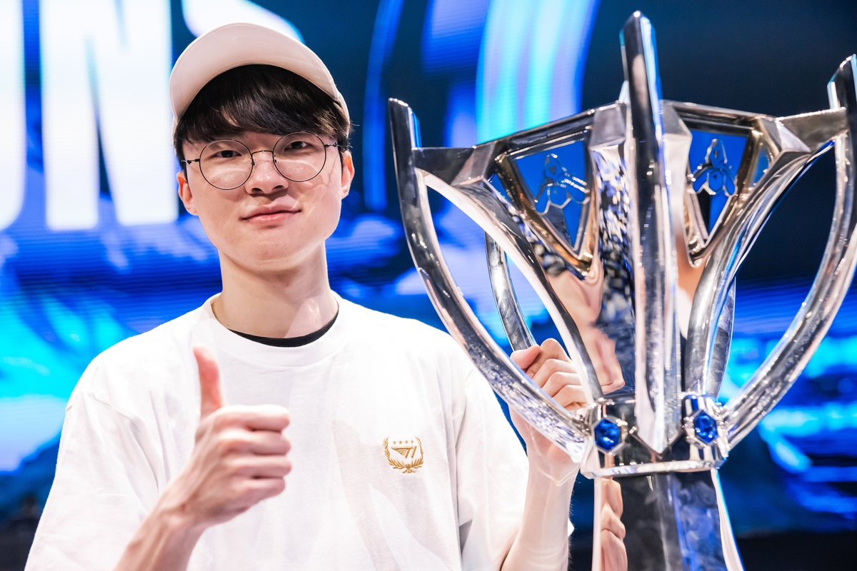 Lee Sang-hyeok, better known as Faker, holds the 2023 League of Legends World Championship trophy following his final match victory in Busan, South Korea, on Nov. 19. (SK Square)