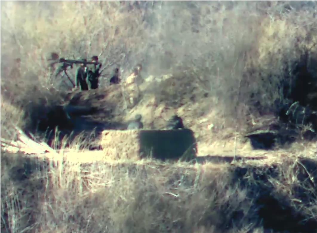 North Korean soldiers are spotted carrying heavy arms near a guard post inside the Demilitarized Zone separating the two Koreas on Monday (Defense Ministry)