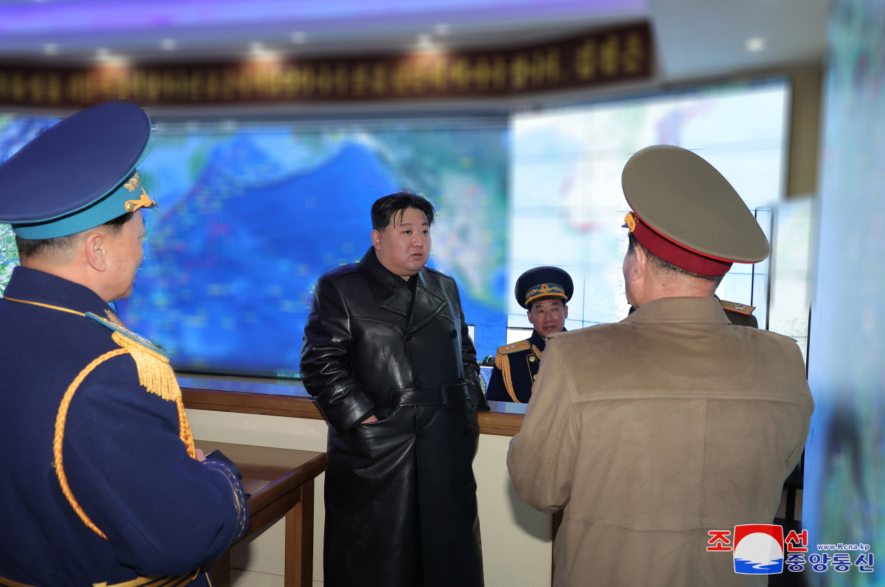 This photo, carried by North Korea's official Korea Central News Agency on Friday, shows the North's leader Kim Jong-un visiting the Air Force Command on the previous day on the occasion of the Day of Airmen. (Yonhap)