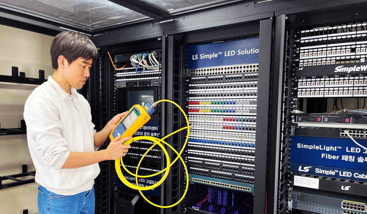 An LS Cable & System employee looks over the company’s new Power over Ethernet cable “SimpleWide 2.0“ at a data center. (LS Cable & System)
