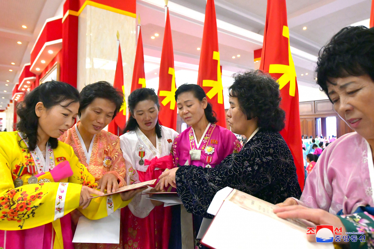 This photo, on Wednesday, shows participants in the Fifth National Conference of Mothers who received gifts from the ruling Workers' Party of Korea the previous day. (Yonhap)