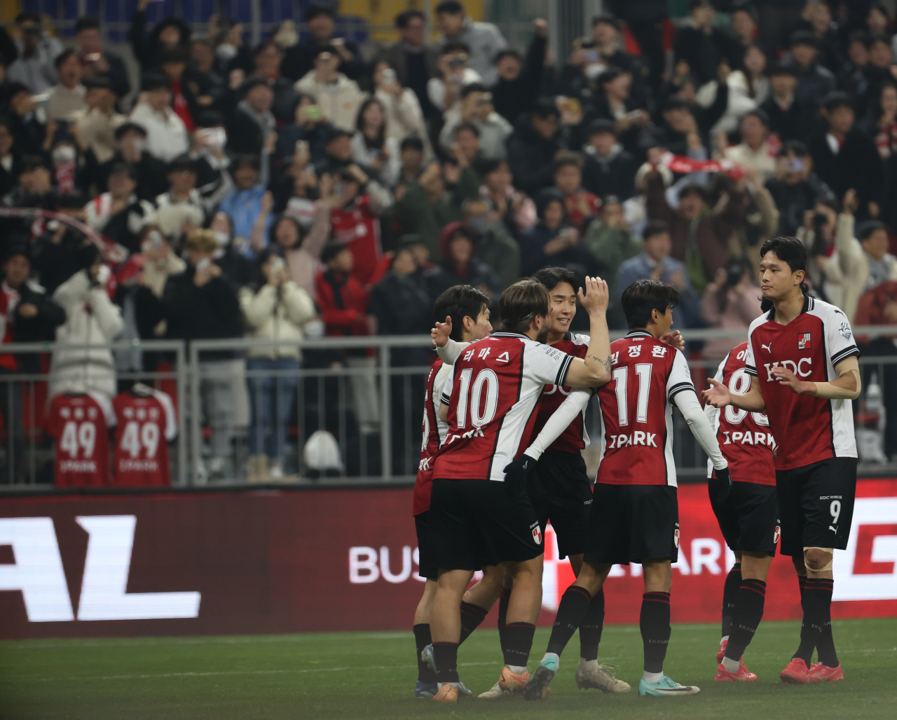 Busan IPark players celebrate after Bruno Lamas (No. 10) scored against Suwon FC during the opening leg of the K League promotion-relegation playoffs at Busan Asiad Main Stadium in the southeastern city of Busan on Wednesday. (Yonhap)