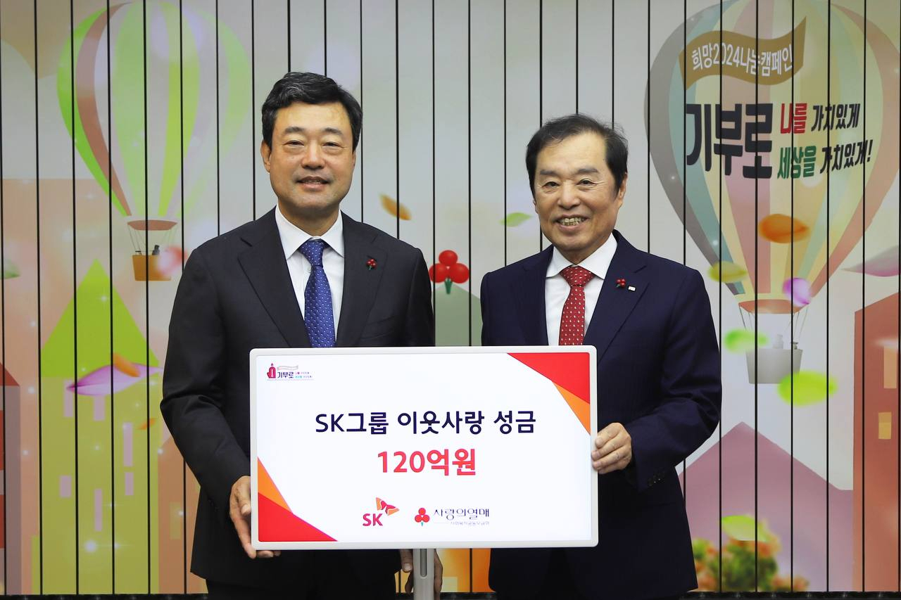 SK Supex Council’s Social Value Committee President Jee Dong-seob (left) and Community Chest of Korea Chair Kim Byong-joon pose for a photo after the group donated 12 billion won to the charity's headquarters in central Seoul on Monday. (SK Group)