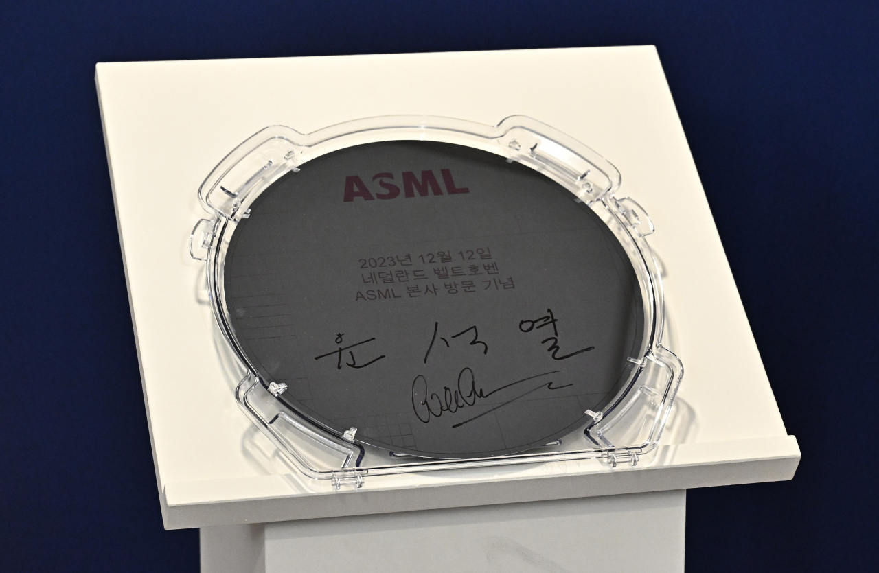This photo shows a semiconductor wafer with President Yoon Suk Yeol's signature on, marking his visit to the headquarters of semiconductor machine maker ASML in Veldhovem the Netherlands, on Tuesday. (Yonhap)